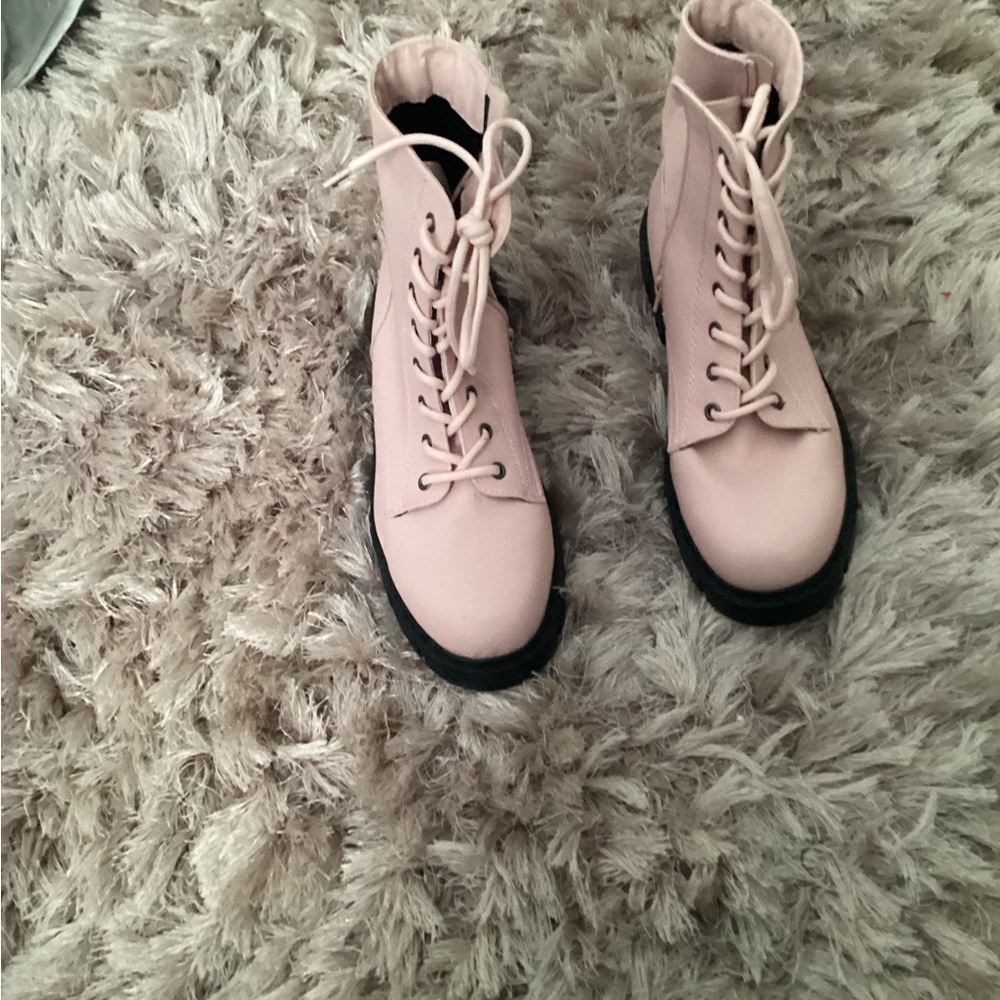 Pink leather combat boots.
